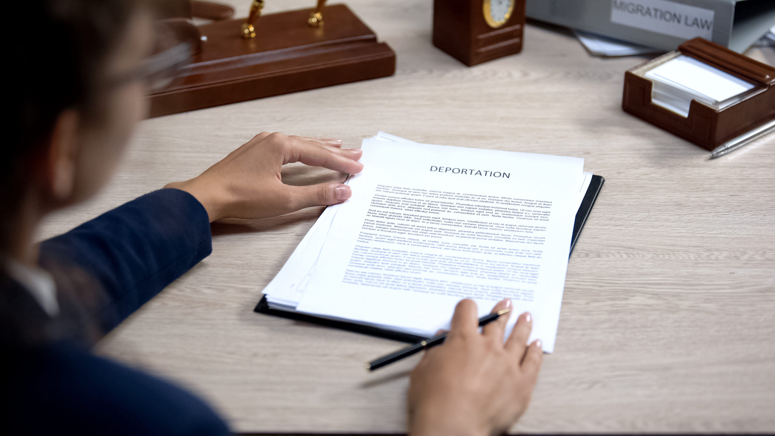 Woman in suit analyzing visa application, migration rules, inter
