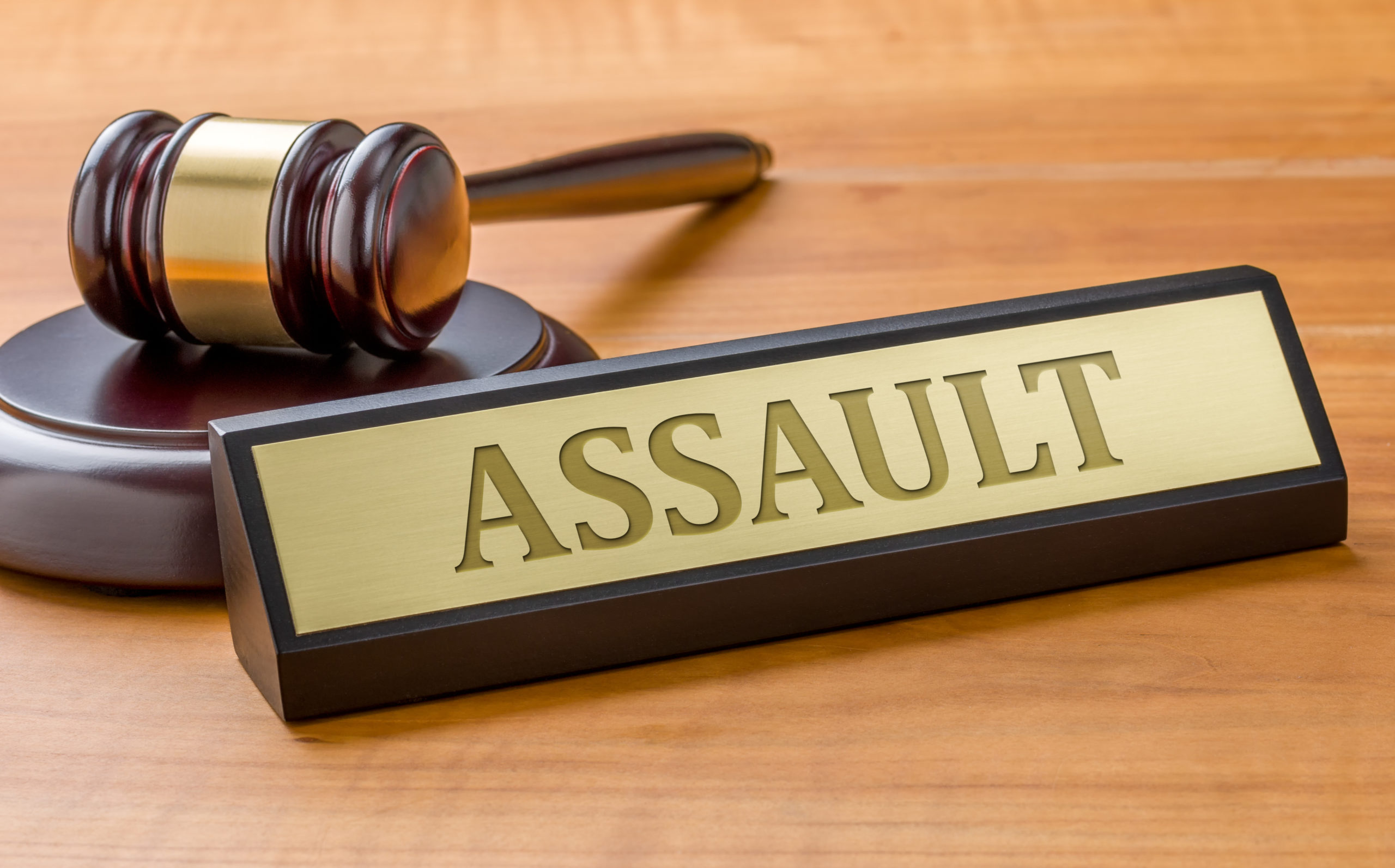 A gavel and a name plate with the engraving Assault