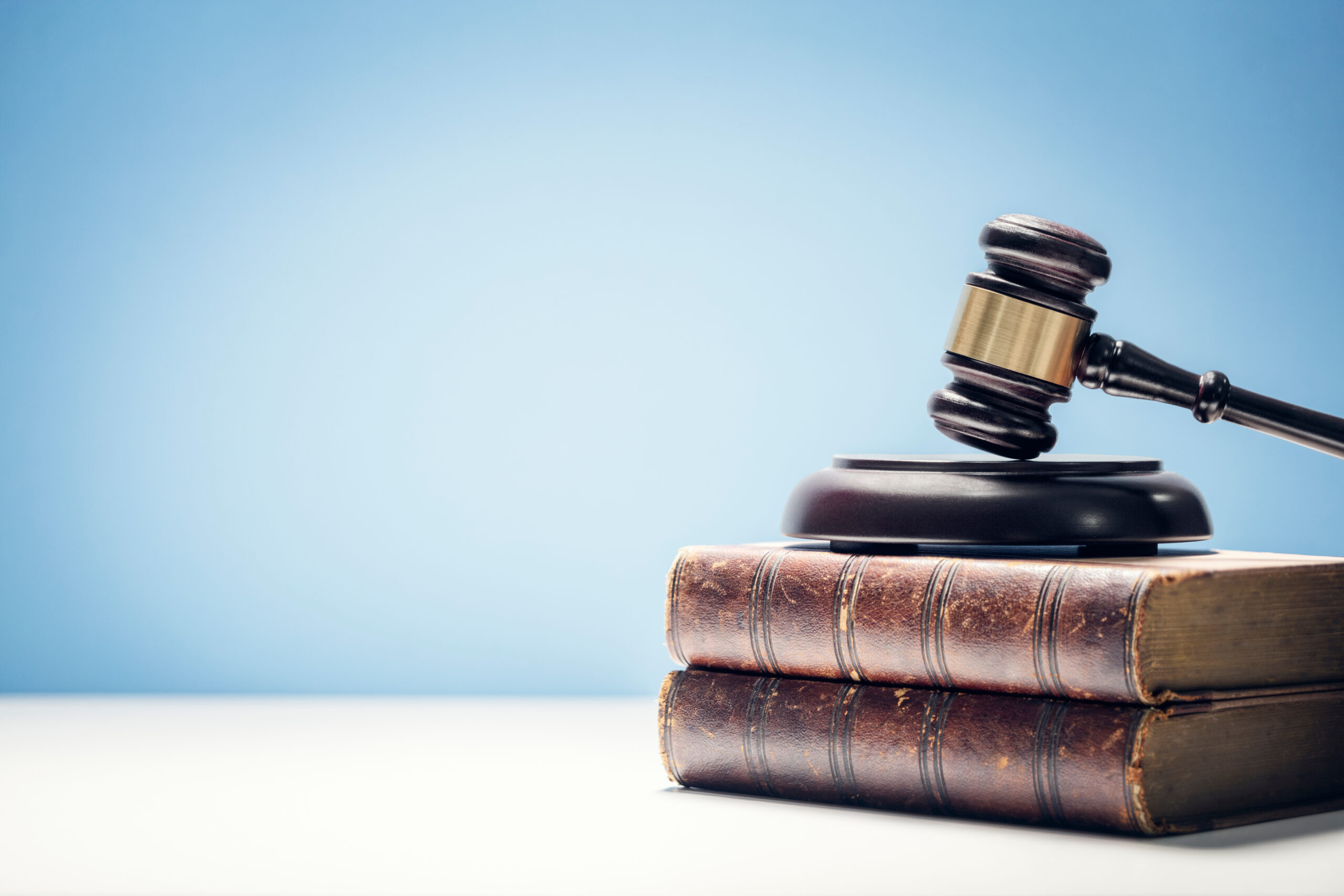 Judge gavel and law books in court background with copy space